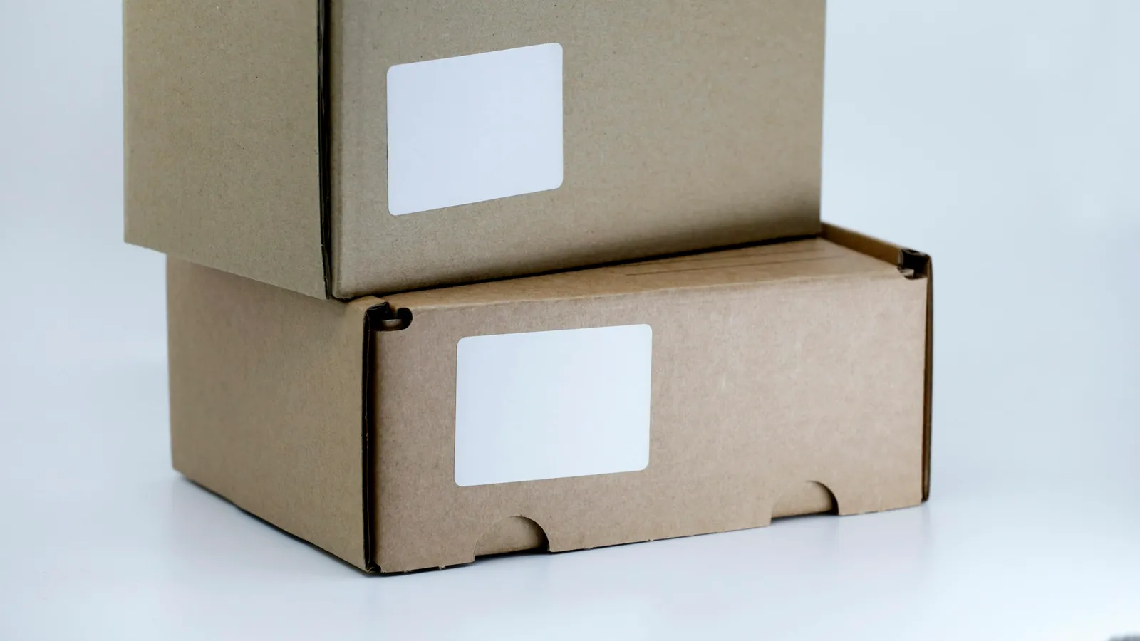 Two plain cardboard shipping boxes with blank labels