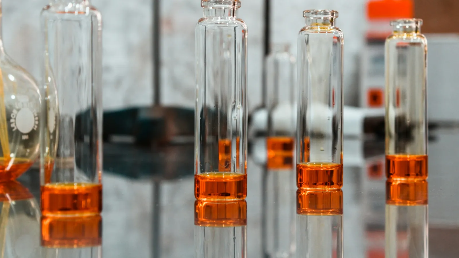 Glass laboratory vials holding amber liquid samples