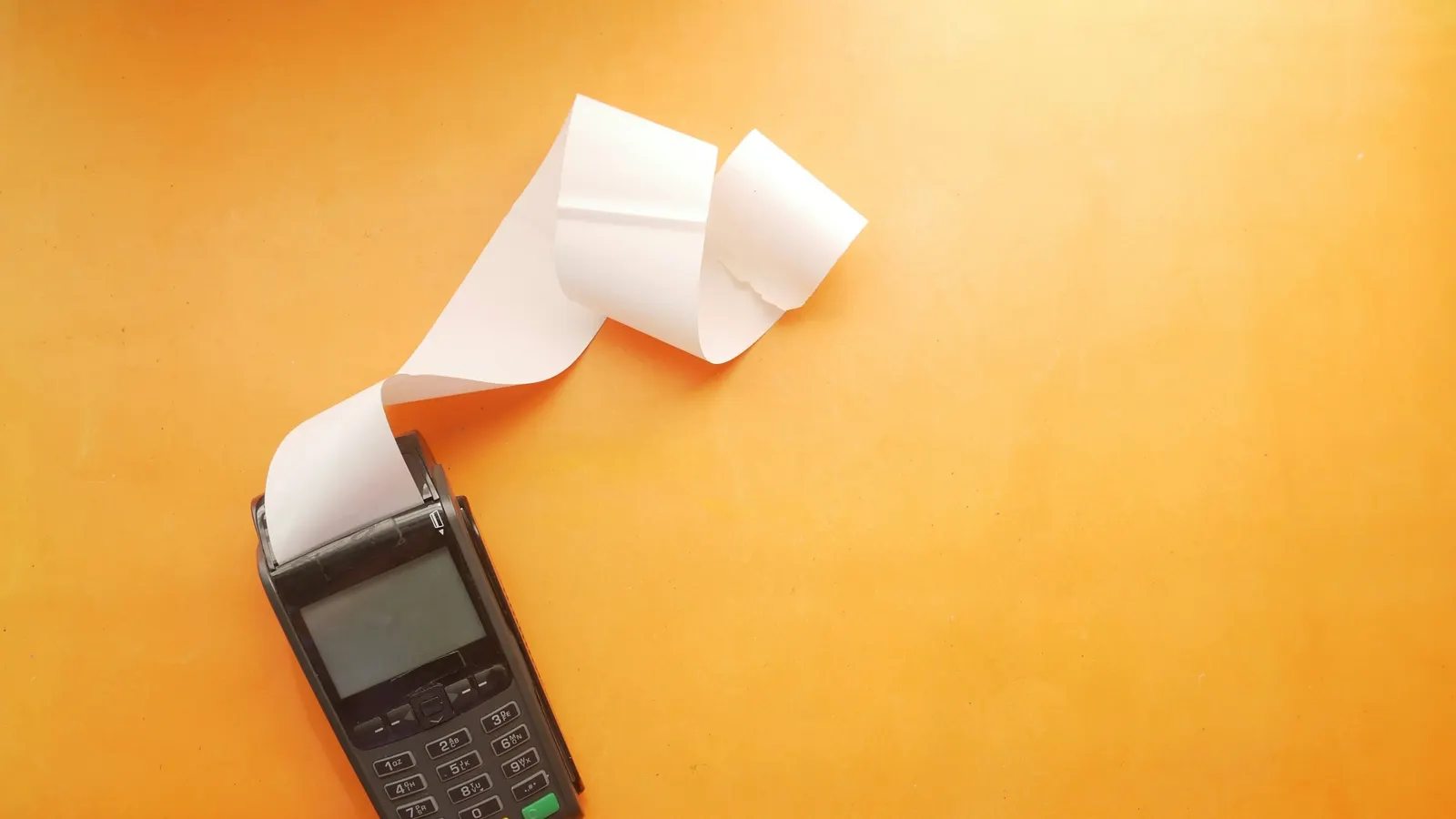 Card terminal printing a long customer receipt, the kind of sales record a gun store uses to answer a chargeback dispute