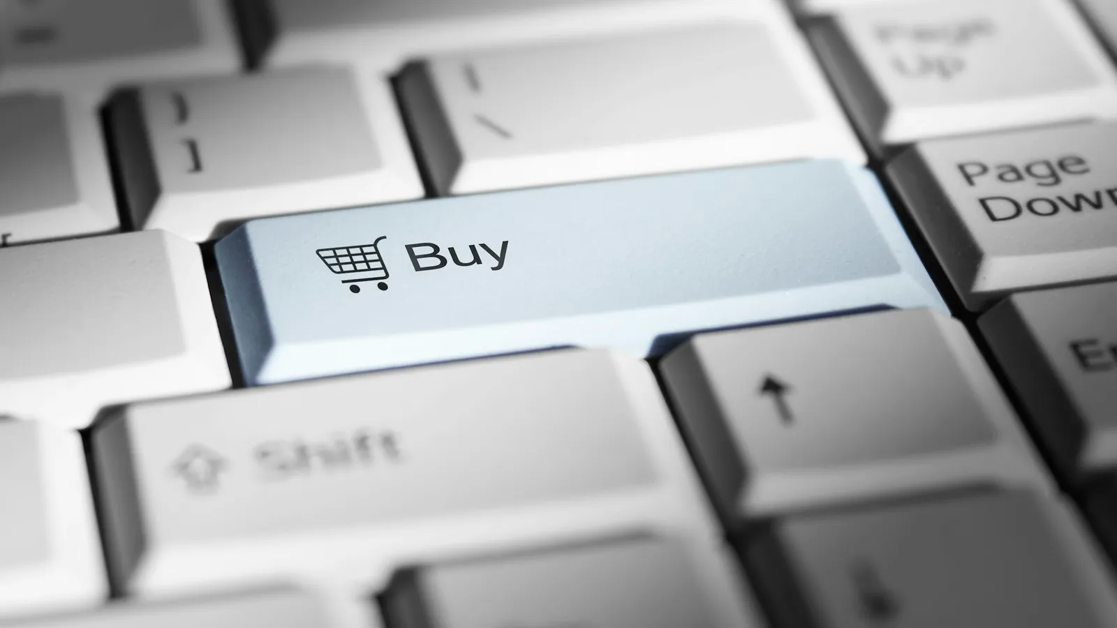 Close-up of a keyboard key labeled Buy with a shopping cart icon